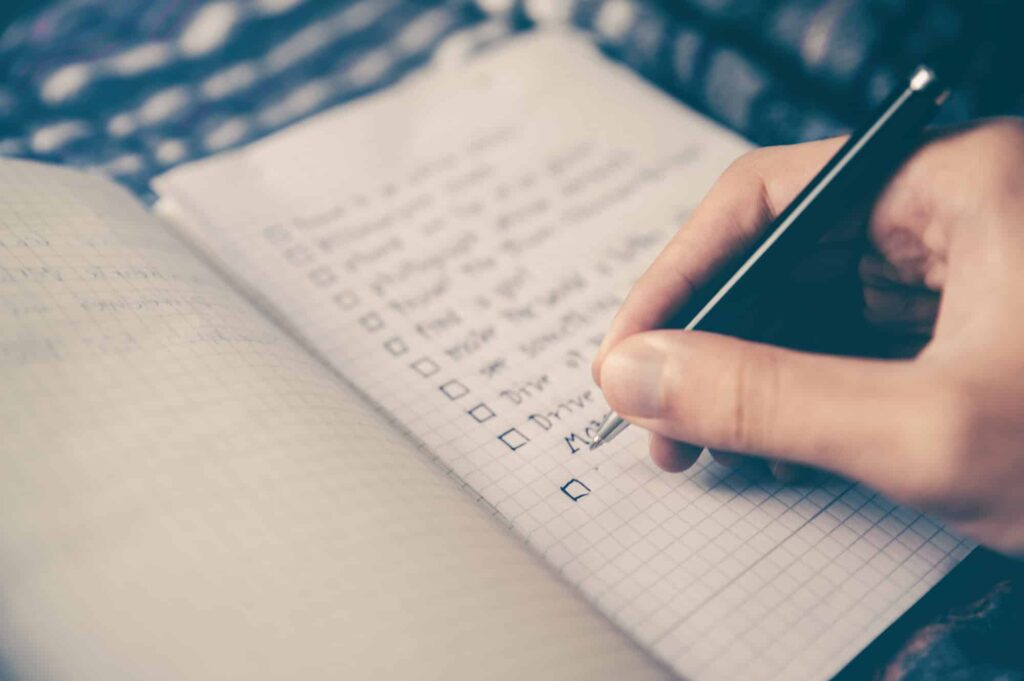 teenage girl journaling out her specific goals